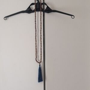 Elegant Brown Beaded Necklace with Blue Tassel